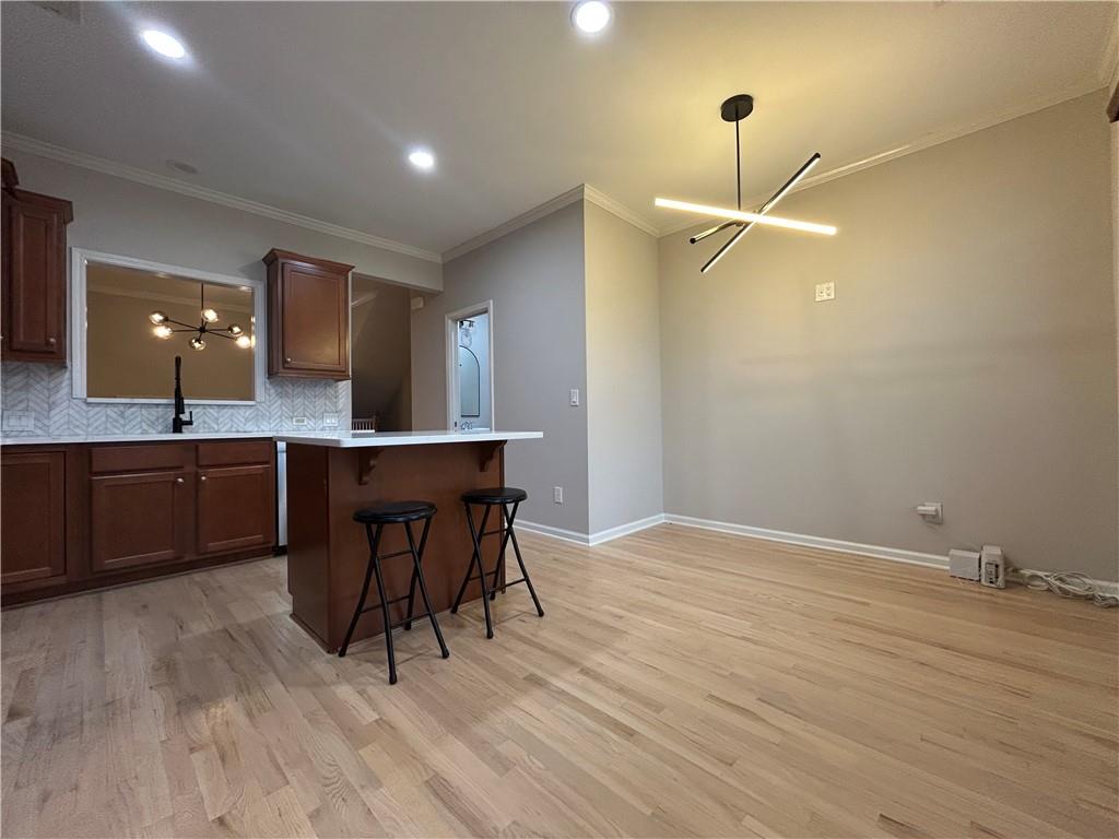 1207 Discover Green Lane, Unit 20 Mableton, GA 30126 - Photo 8 of 29 a living room with stainless steel appliances kitchen island a table chairs and a sink