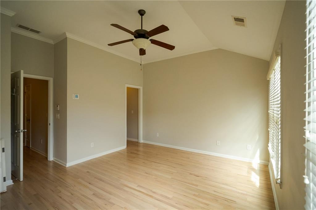 1207 Discover Green Lane, Unit 20 Mableton, GA 30126 - Photo 10 of 29 a view of a big room with wooden floor and a ceiling fan
