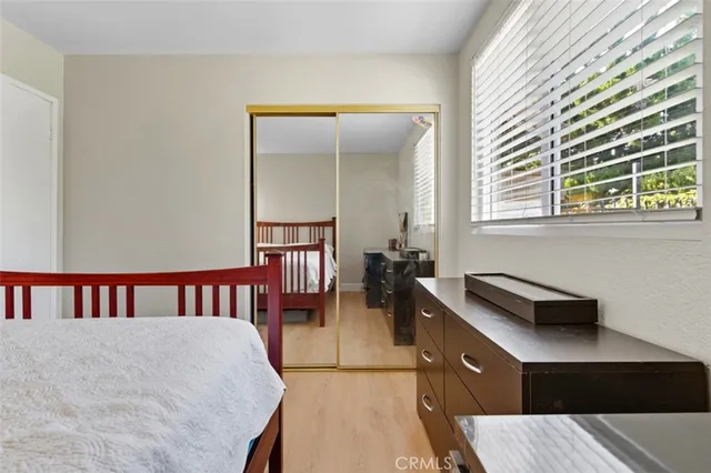 a bedroom with furniture and a window