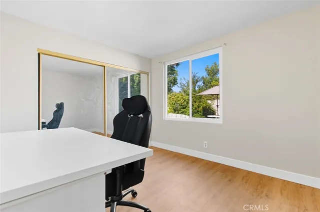 a view of a room that has a dresser and mirror in it