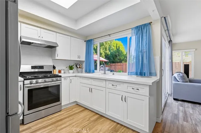 a view of backyard with outdoor seating and trees
