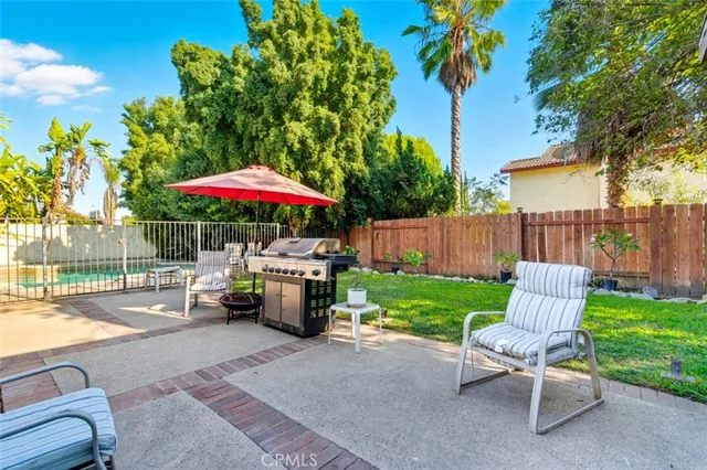 a view of a house with backyard and sitting area