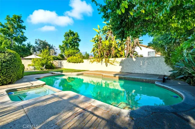 an aerial view of residential houses with outdoor space and parking
