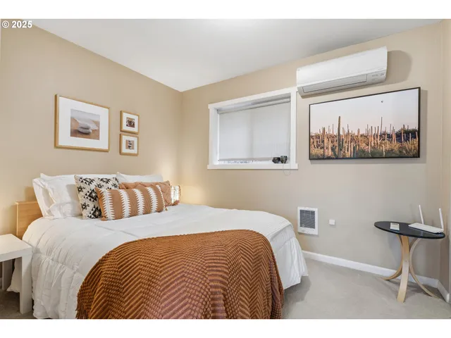 a bedroom with a bed and a painting on the wall