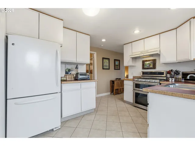 a kitchen with stainless steel appliances granite countertop a refrigerator sink and cabinets