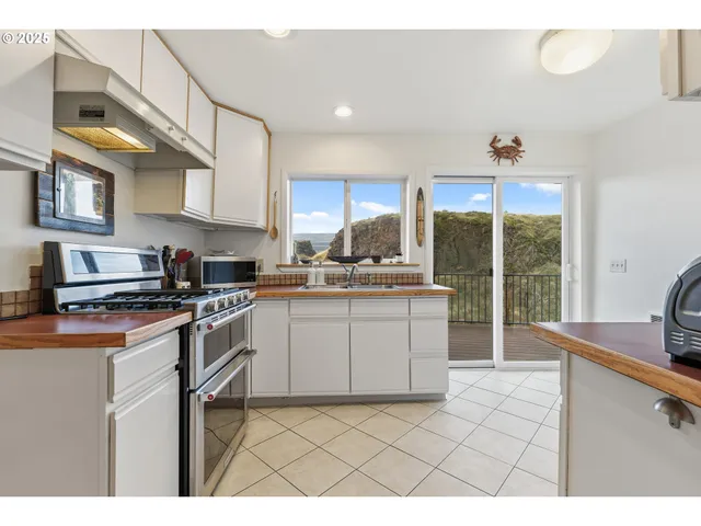 a kitchen with a sink a stove and cabinets