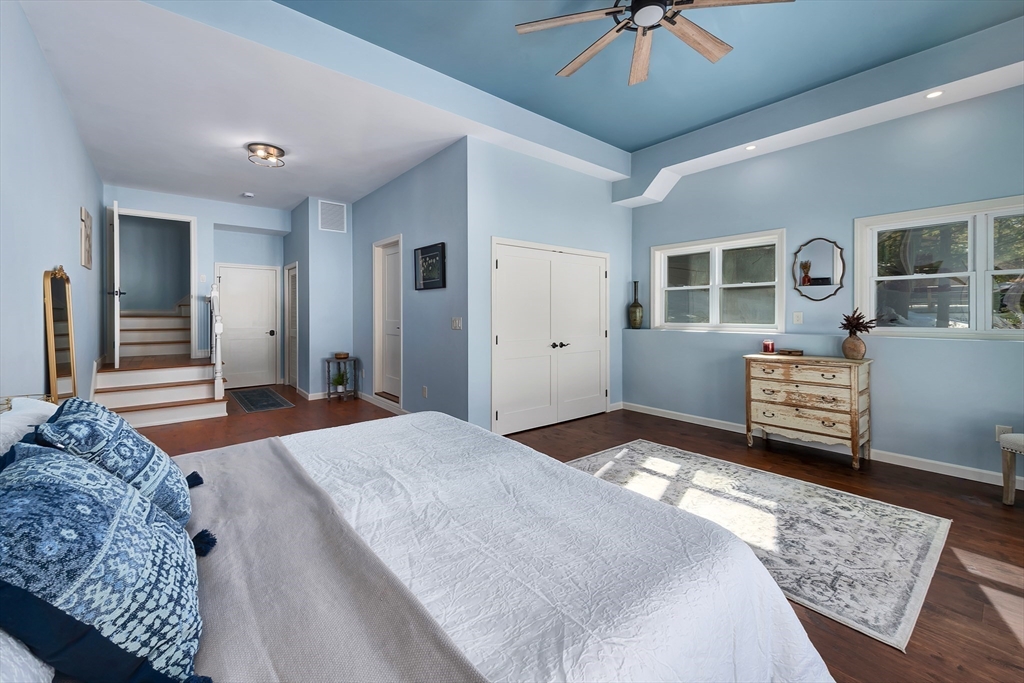 108 Stiles Pond Road Boxford, MA 01921 - Photo 27 of 38 a bedroom with a bed and a chandelier