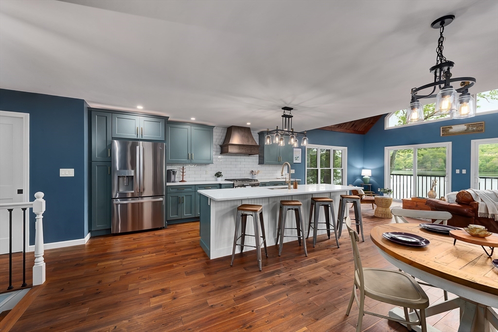 108 Stiles Pond Road Boxford, MA 01921 - Photo 3 of 38 a kitchen with stainless steel appliances granite countertop a stove refrigerator and a dining table