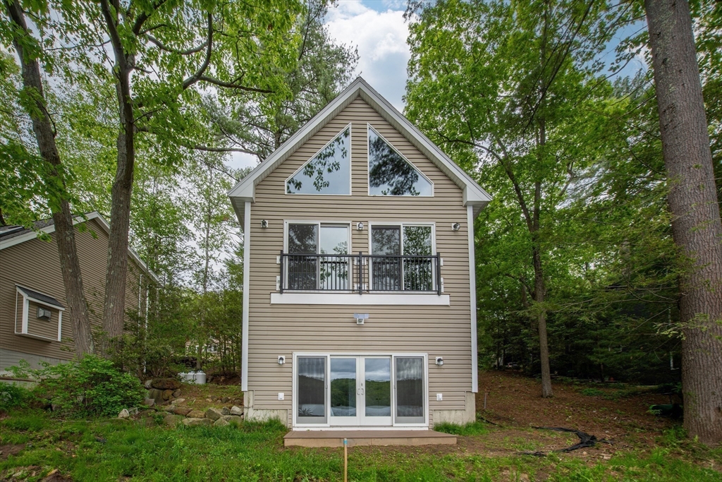 108 Stiles Pond Road Boxford, MA 01921 - Photo 36 of 38 a front view of a house with yard and green space