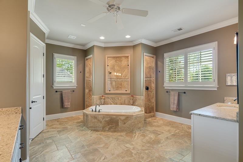 336 Pisgah Road Eads, TN 38028 - Photo 11 of 25 Spacious and sophisticated, this bath offers heated floors, an extra large walk through pebble floor shower, double sinks, and linen closet, plus premium granite and lighting.