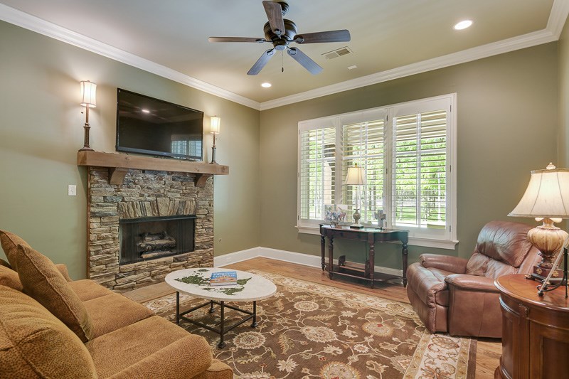 336 Pisgah Road Eads, TN 38028 - Photo 13 of 25 This cozy and enchanting room has recessed lighting, stacked stone gas fireplace with cedar mantel, wood floors, and unique glass panel entry door.