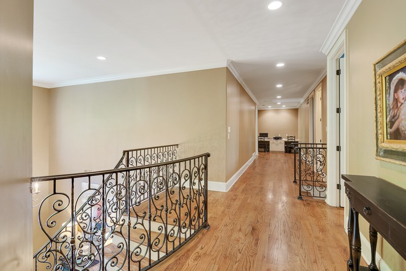 336 Pisgah Road Eads, TN 38028 - Photo 14 of 25 Another extra wide hallway with rich wood flooring and recessed lighting houses a custom built desk area on one end, and entry to both staircases.