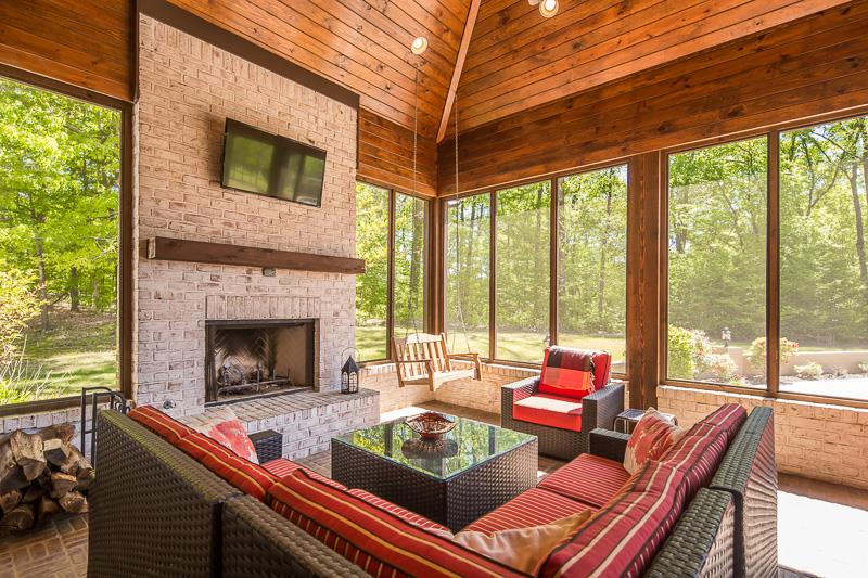 336 Pisgah Road Eads, TN 38028 - Photo 20 of 25 One of multiple enchanting outdoor living spaces with brick flooring, wood coffered ceiling, wood burning fireplace, swing, and sliding glass doors to great room.