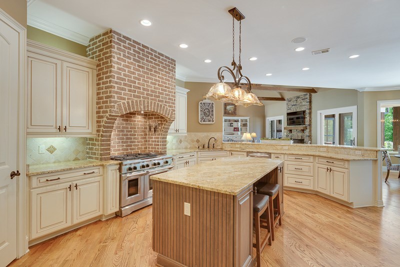 336 Pisgah Road Eads, TN 38028 - Photo 4 of 25 Brick wall and custom backsplash are the focal point of this magnificent kitchen. It also includes a coffee station with water dispenser, island, massive breakfast bar, and completely separate exclusive butler's pantry (not pictured).