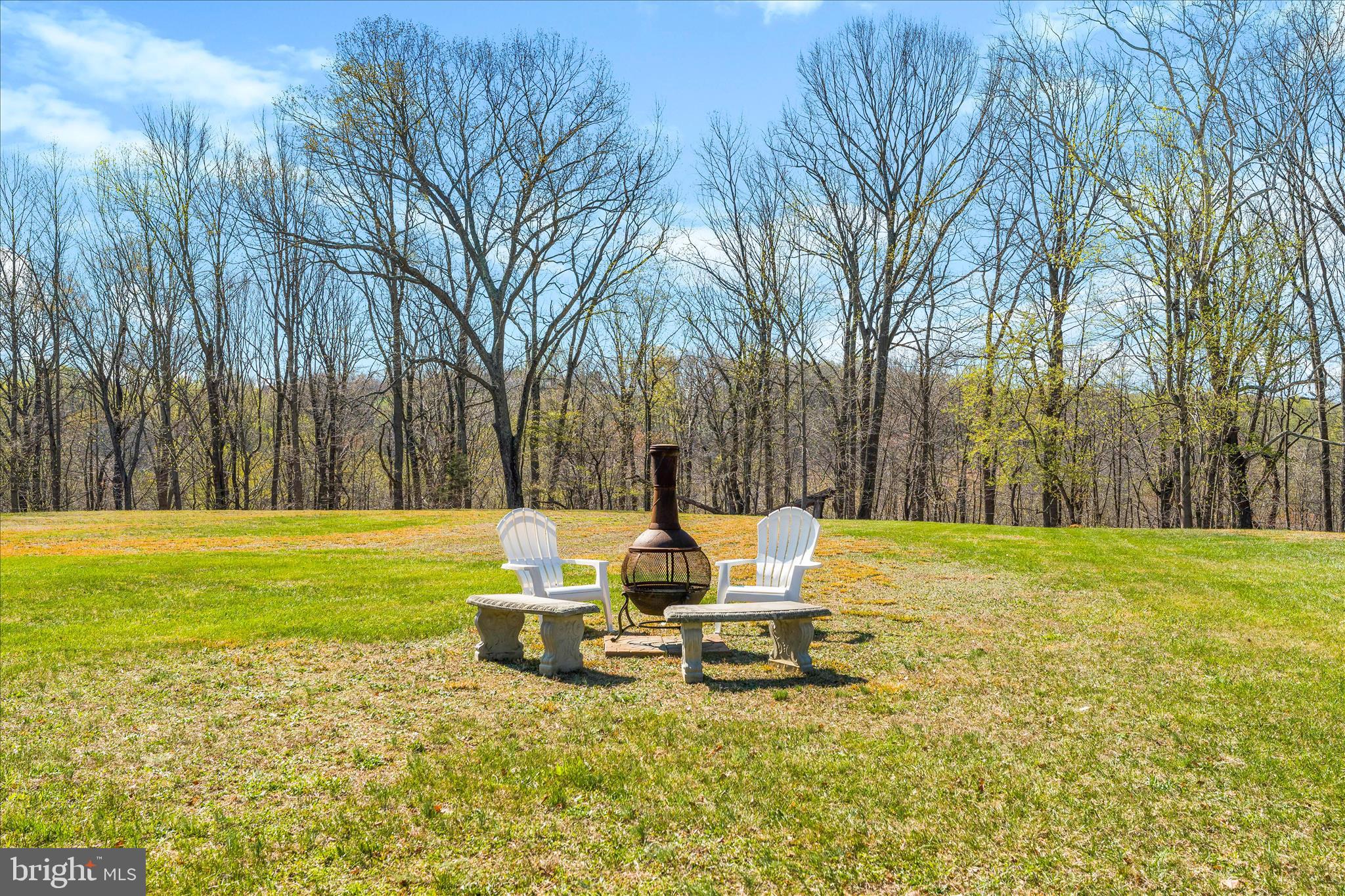 3033 Averley Road Ijamsville, MD 21754 - Photo 25 of 115 a chair and bench sitting in the middle of a field