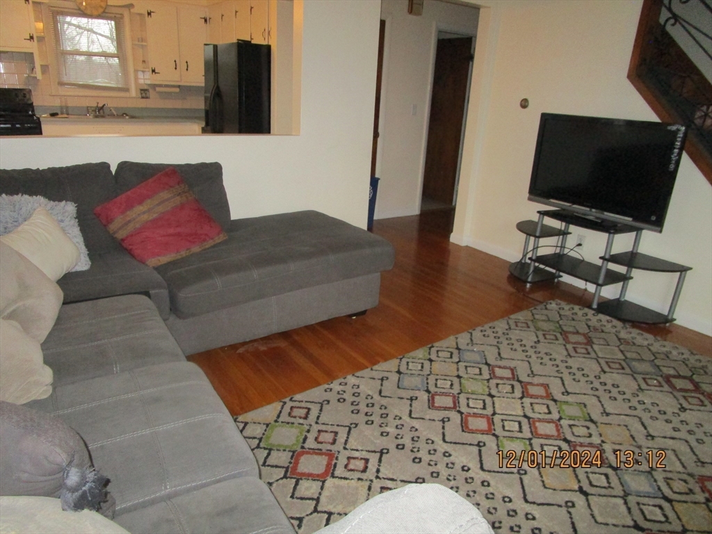 282 Central Street, Unit 1 Auburn, MA 01501 - Photo 12 of 16 a living room with a couch and a flat screen tv