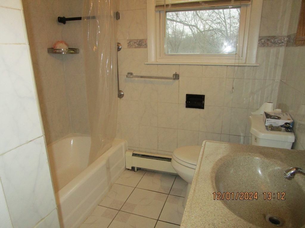 282 Central Street, Unit 1 Auburn, MA 01501 - Photo 13 of 16 a bathroom with a tub and a shower