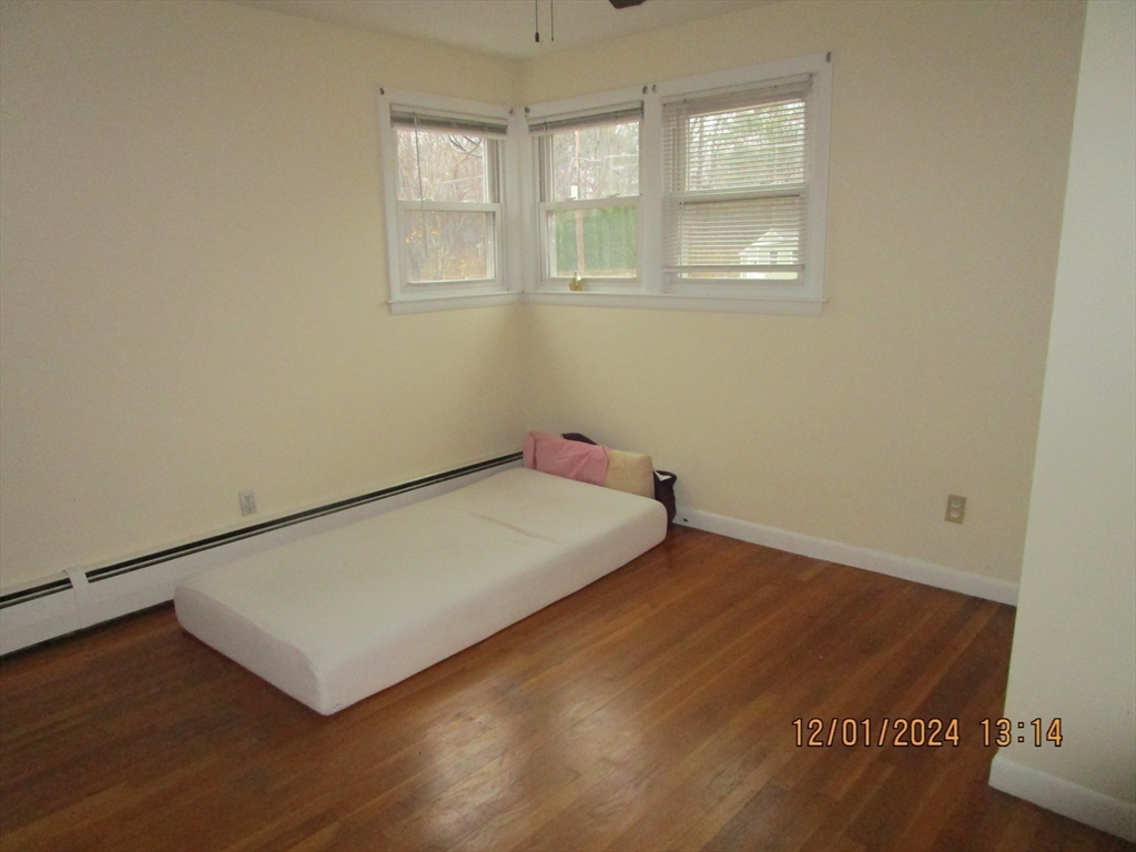 282 Central Street, Unit 1 Auburn, MA 01501 - Photo 15 of 16 a view of a room with wooden floor and window