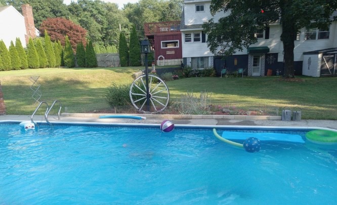 282 Central Street, Unit 1 Auburn, MA 01501 - Photo 2 of 16 a view of a swimming pool with a yard