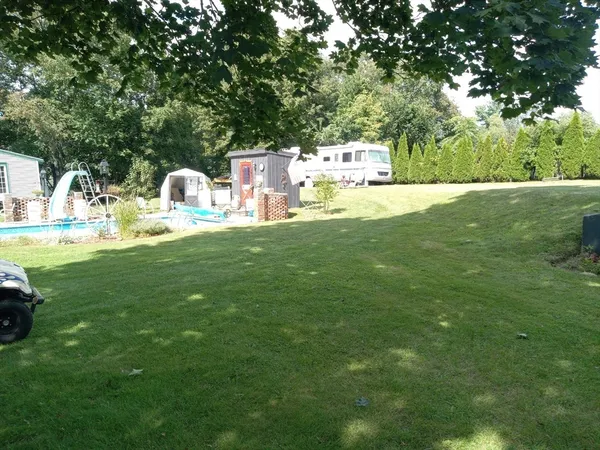 a view of a house with a yard porch and sitting area