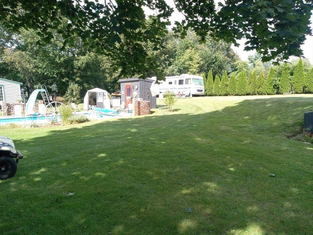 282 Central Street, Unit 1 Auburn, MA 01501 - Photo 3 of 16 a view of a house with a yard porch and sitting area