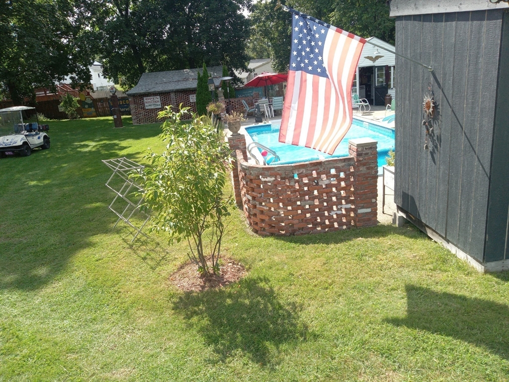 282 Central Street, Unit 1 Auburn, MA 01501 - Photo 6 of 16 a view of a yard in front of a house with a large tree