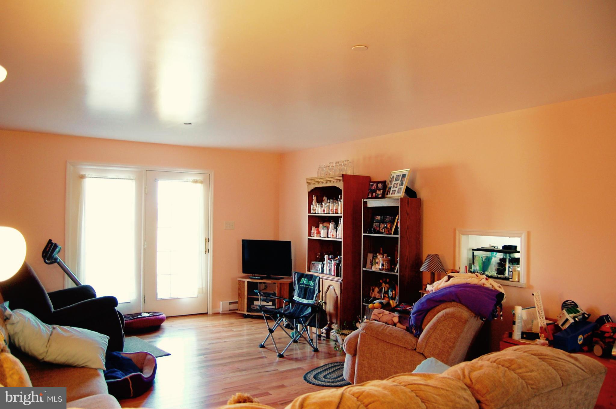 11747 Cash Smith Road Keymar, MD 21757 - Photo 7 of 14 a living room with furniture and a flat screen tv