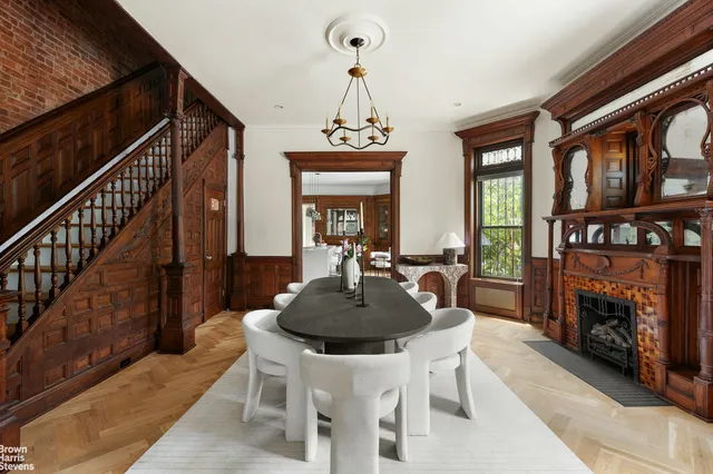 a dining room with furniture a fireplace and a chandelier