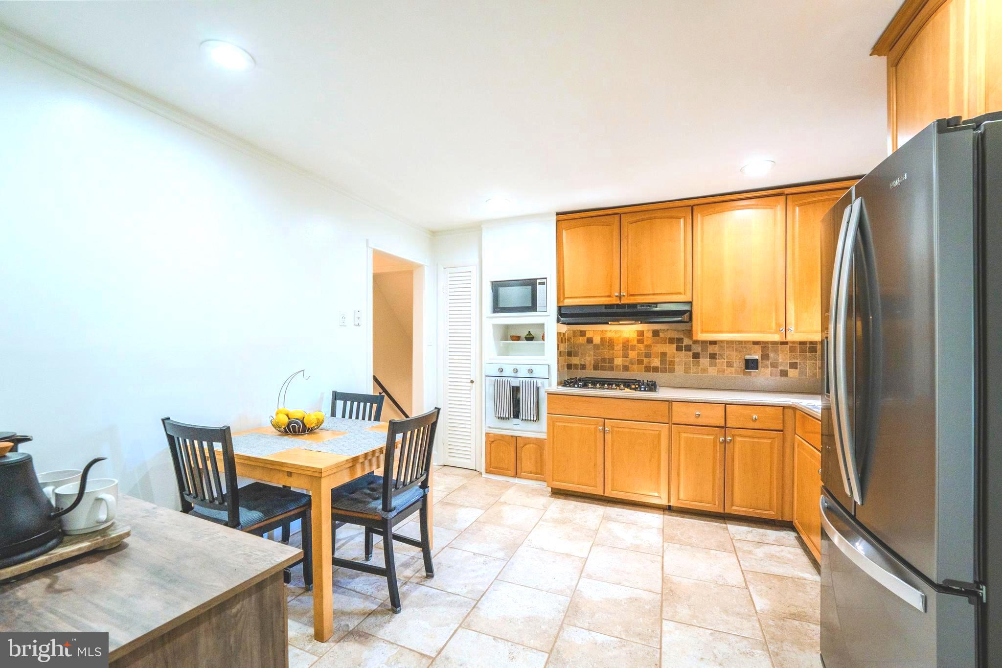 6705 Bracken Court Springfield, VA 22152 - Photo 13 of 40 a kitchen with a table and chairs in it