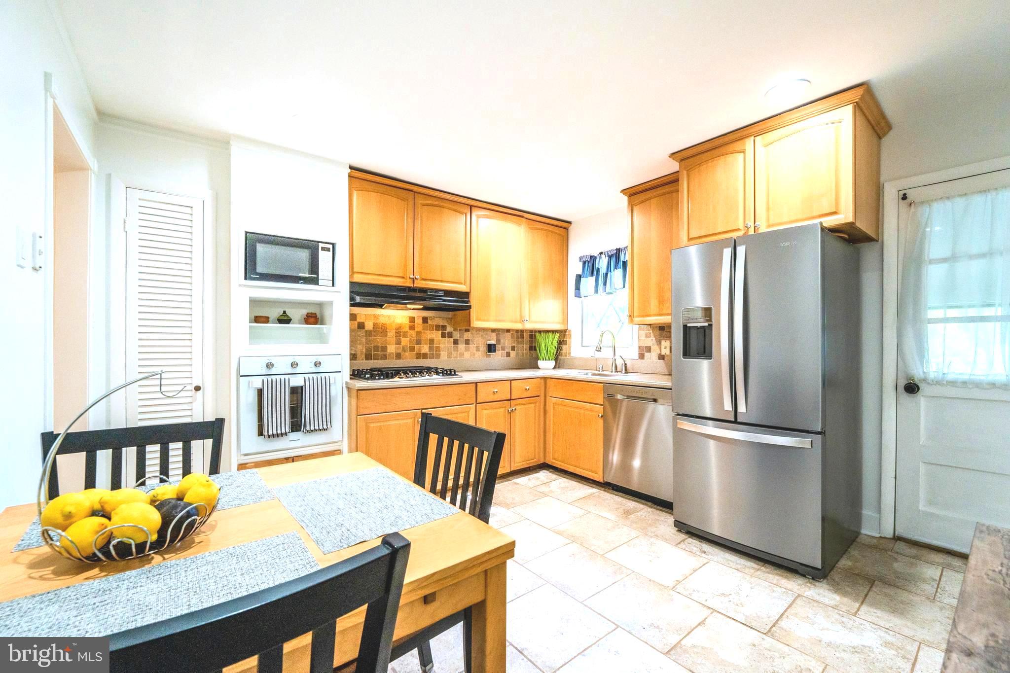 6705 Bracken Court Springfield, VA 22152 - Photo 14 of 40 a kitchen with stainless steel appliances granite countertop a refrigerator a stove and a sink with granite countertops