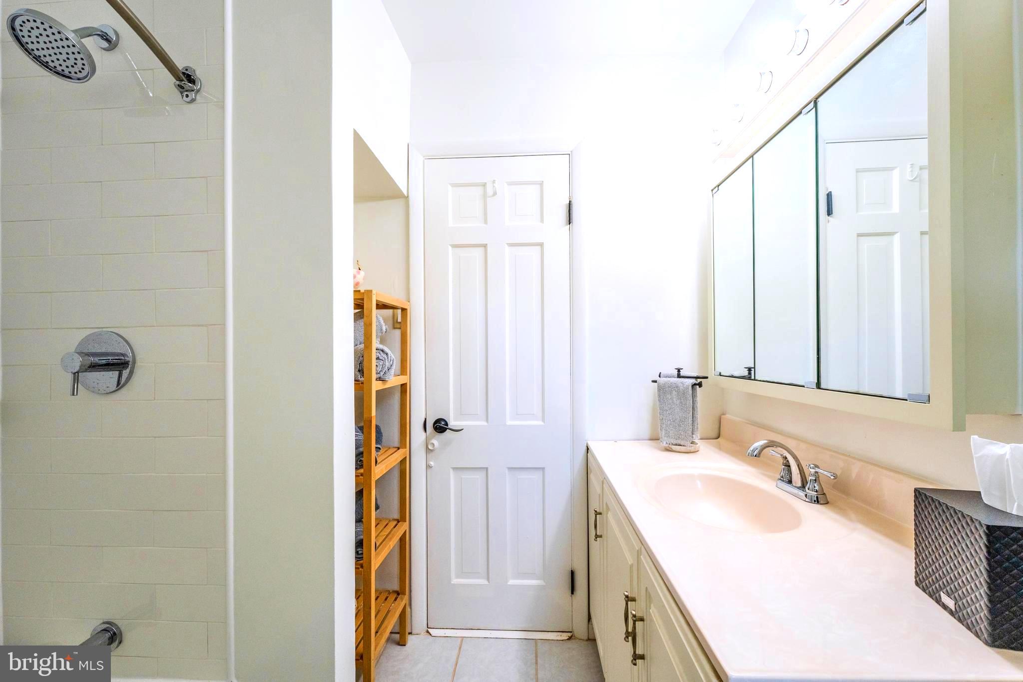 6705 Bracken Court Springfield, VA 22152 - Photo 22 of 40 a bathroom with a granite countertop sink and a mirror