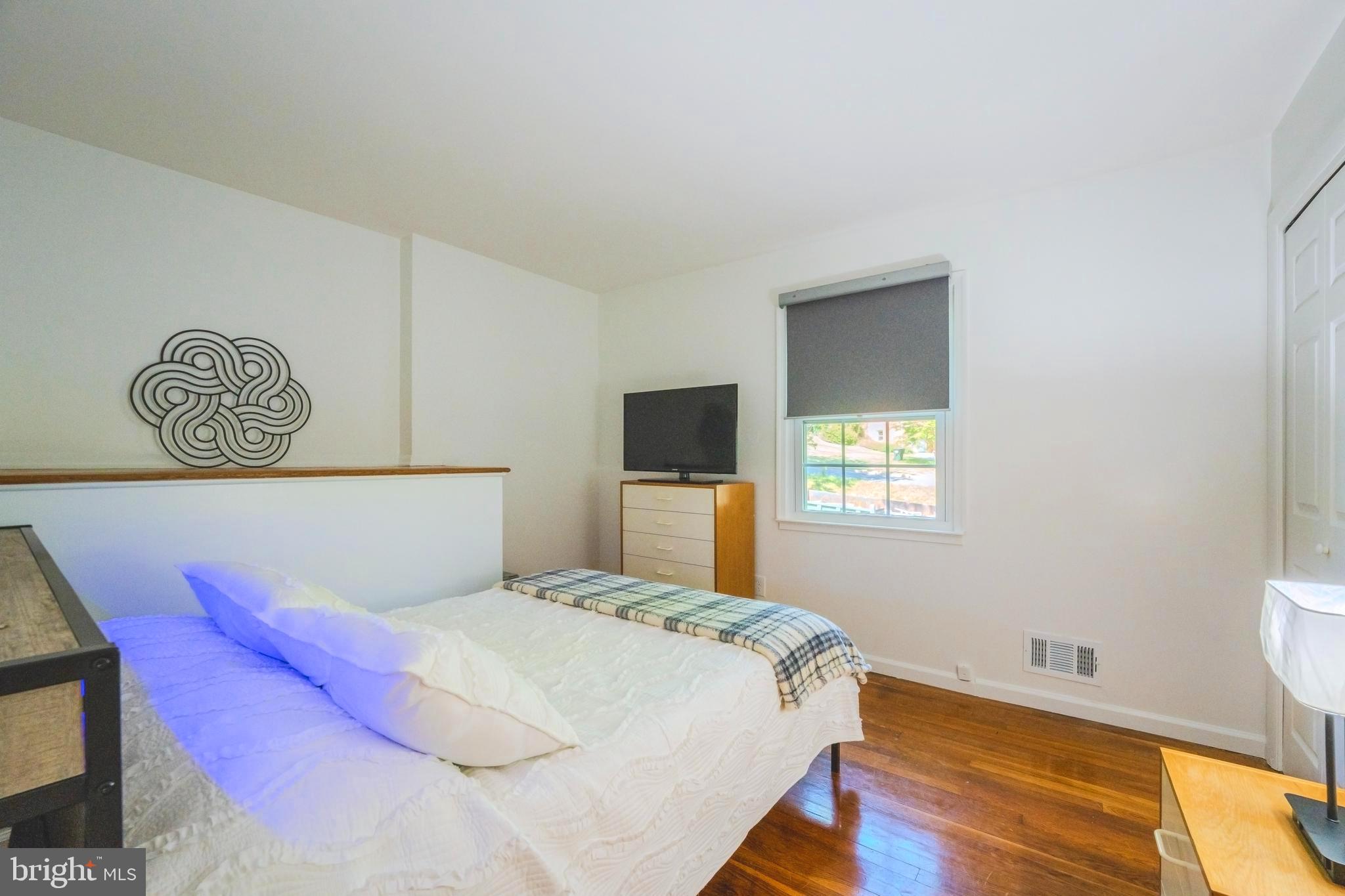 6705 Bracken Court Springfield, VA 22152 - Photo 23 of 40 a bedroom with a bed and a window