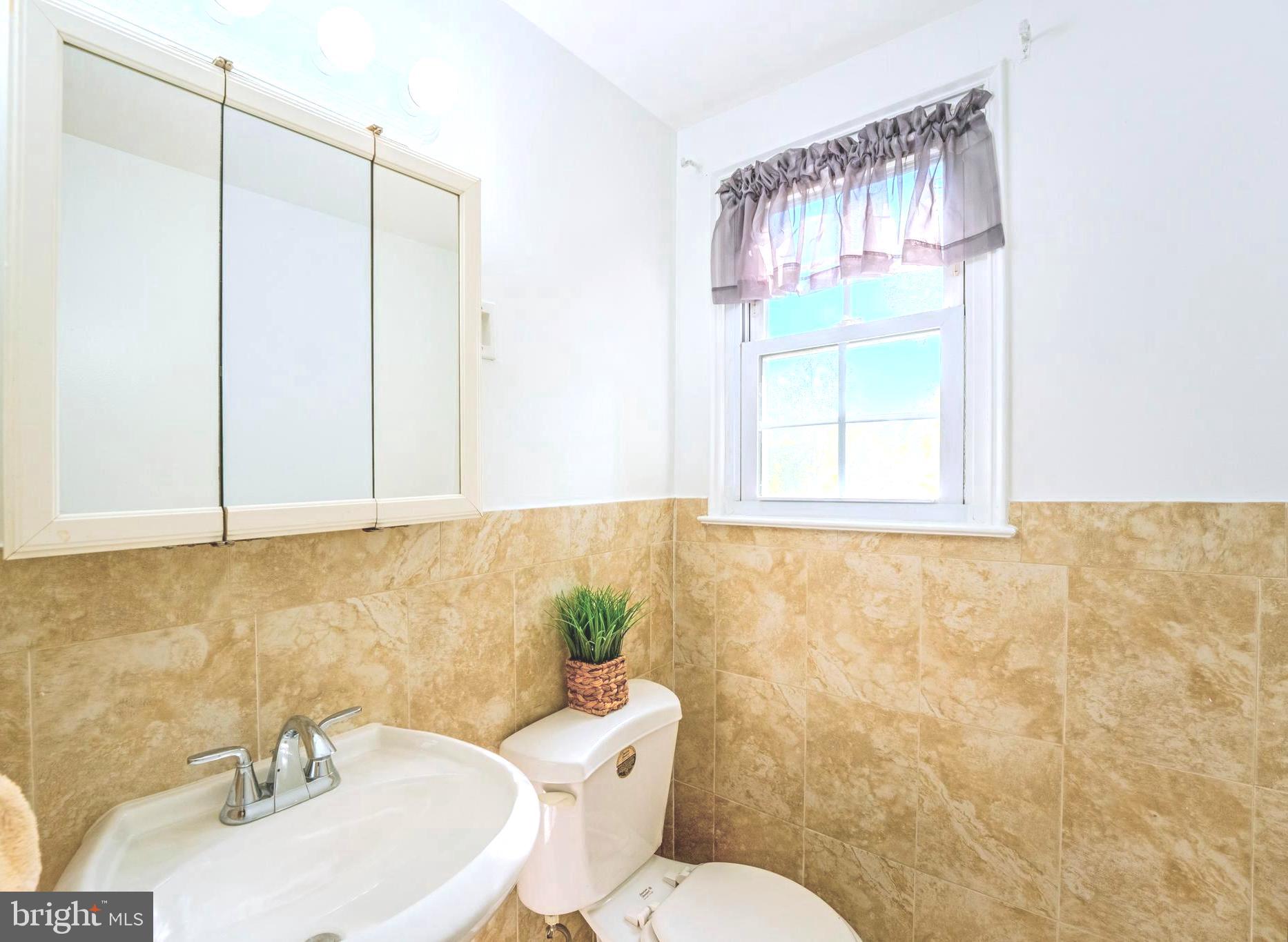 6705 Bracken Court Springfield, VA 22152 - Photo 25 of 40 a bathroom with a sink a toilet and a mirror