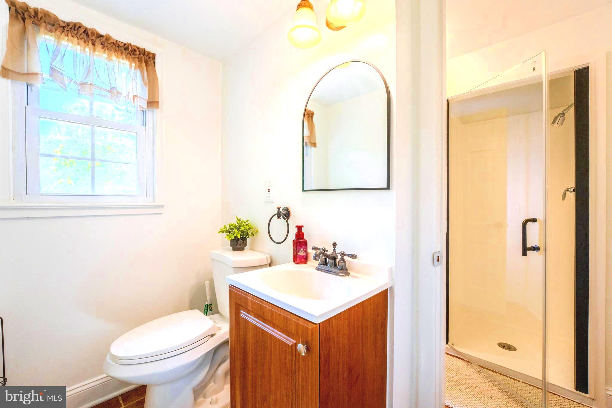 6705 Bracken Court Springfield, VA 22152 - Photo 32 of 40 a bathroom with a toilet sink and mirror