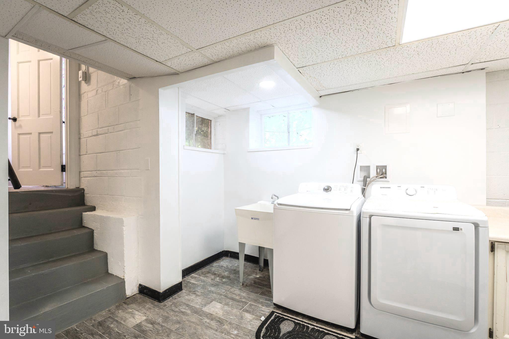 6705 Bracken Court Springfield, VA 22152 - Photo 33 of 40 a utility room with cabinets washer and dryer
