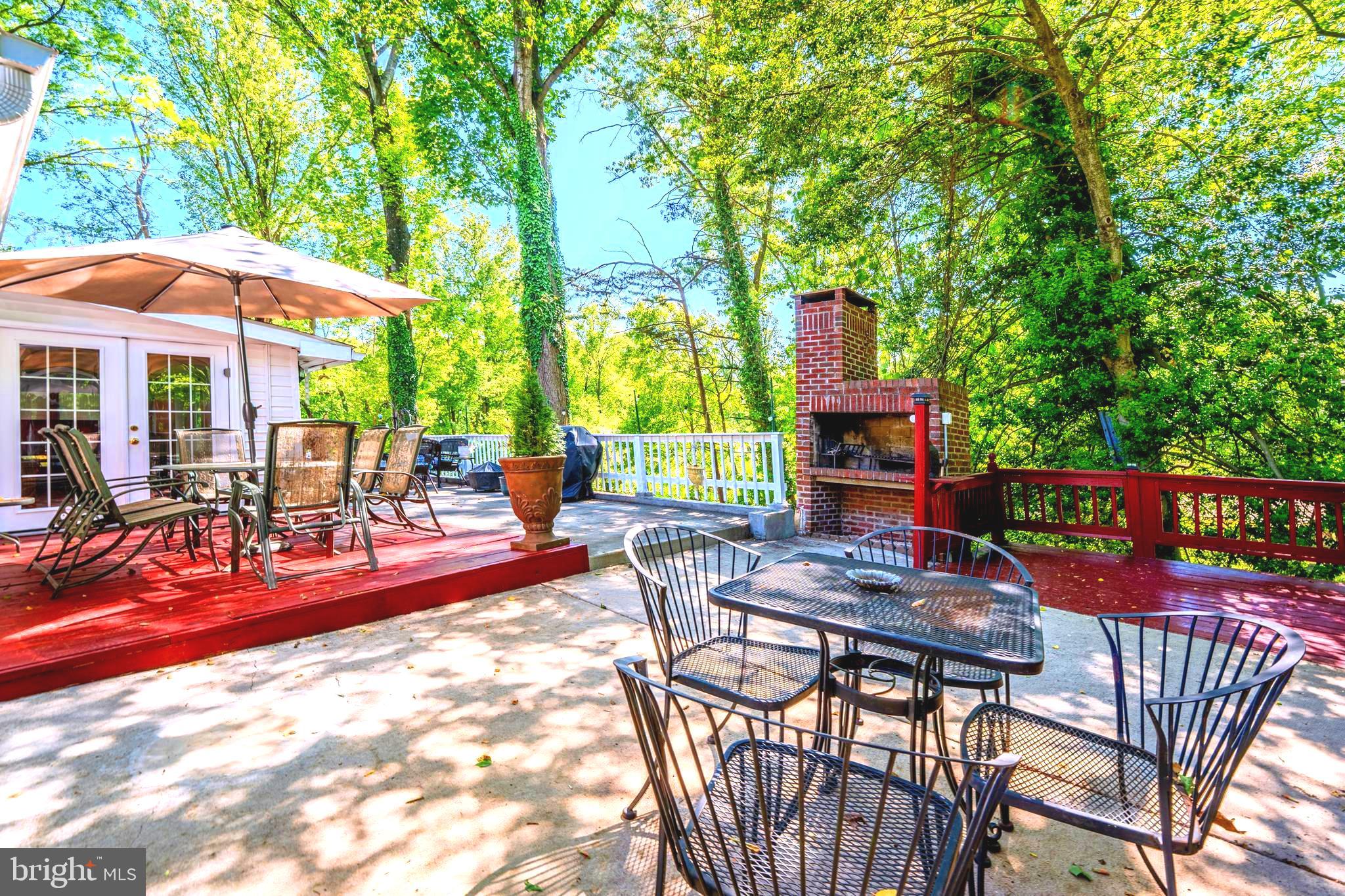 6705 Bracken Court Springfield, VA 22152 - Photo 36 of 40 a view of a patio with table and chairs under an umbrella