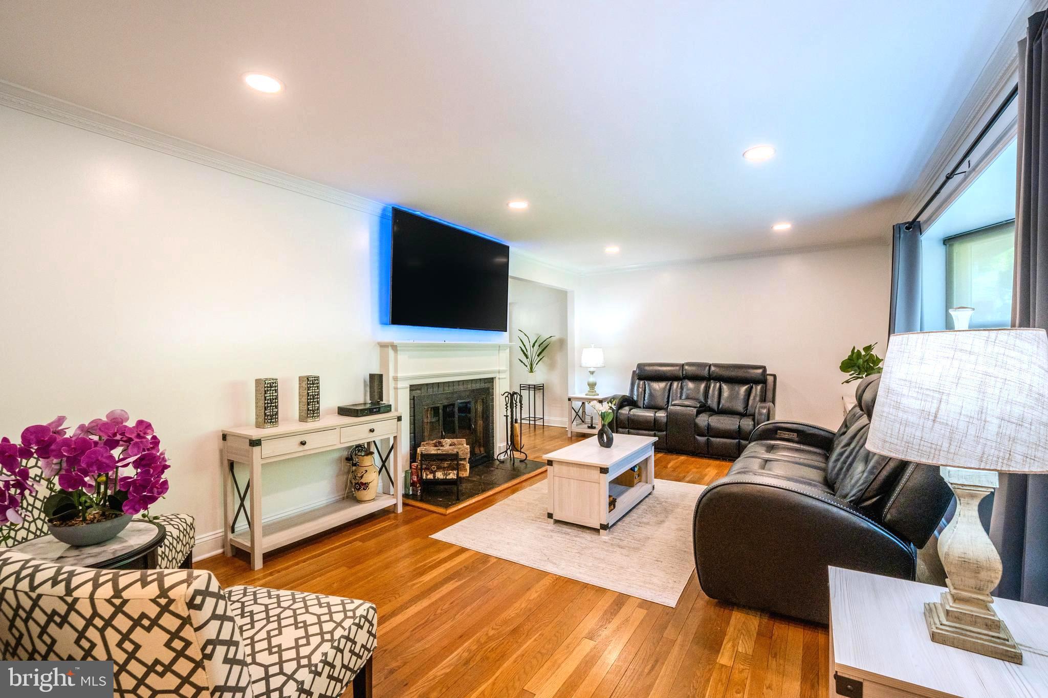 6705 Bracken Court Springfield, VA 22152 - Photo 5 of 40 a living room with furniture fireplace and a flat screen tv