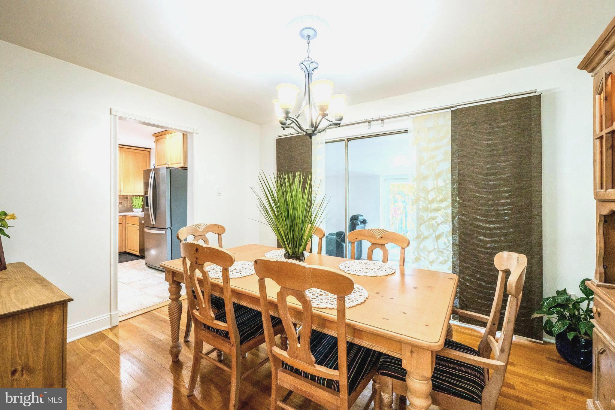6705 Bracken Court Springfield, VA 22152 - Photo 9 of 40 a view of a dining room with furniture and wooden floor