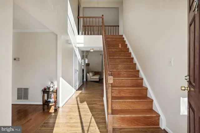 a view of entryway and hall with wooden floor