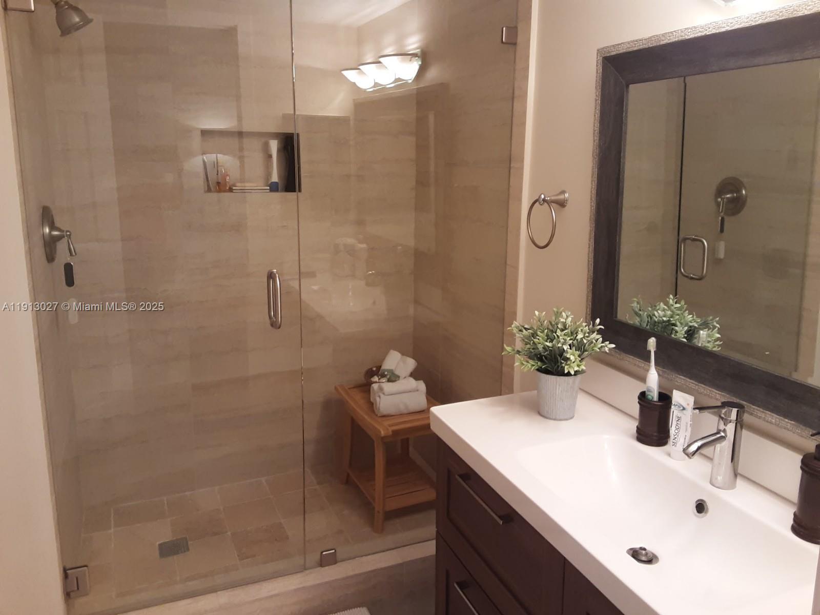 9409 Fontainebleau Boulevard, Unit 207 Miami, FL 33172 - Photo 12 of 19 a bathroom with a sink and a mirror