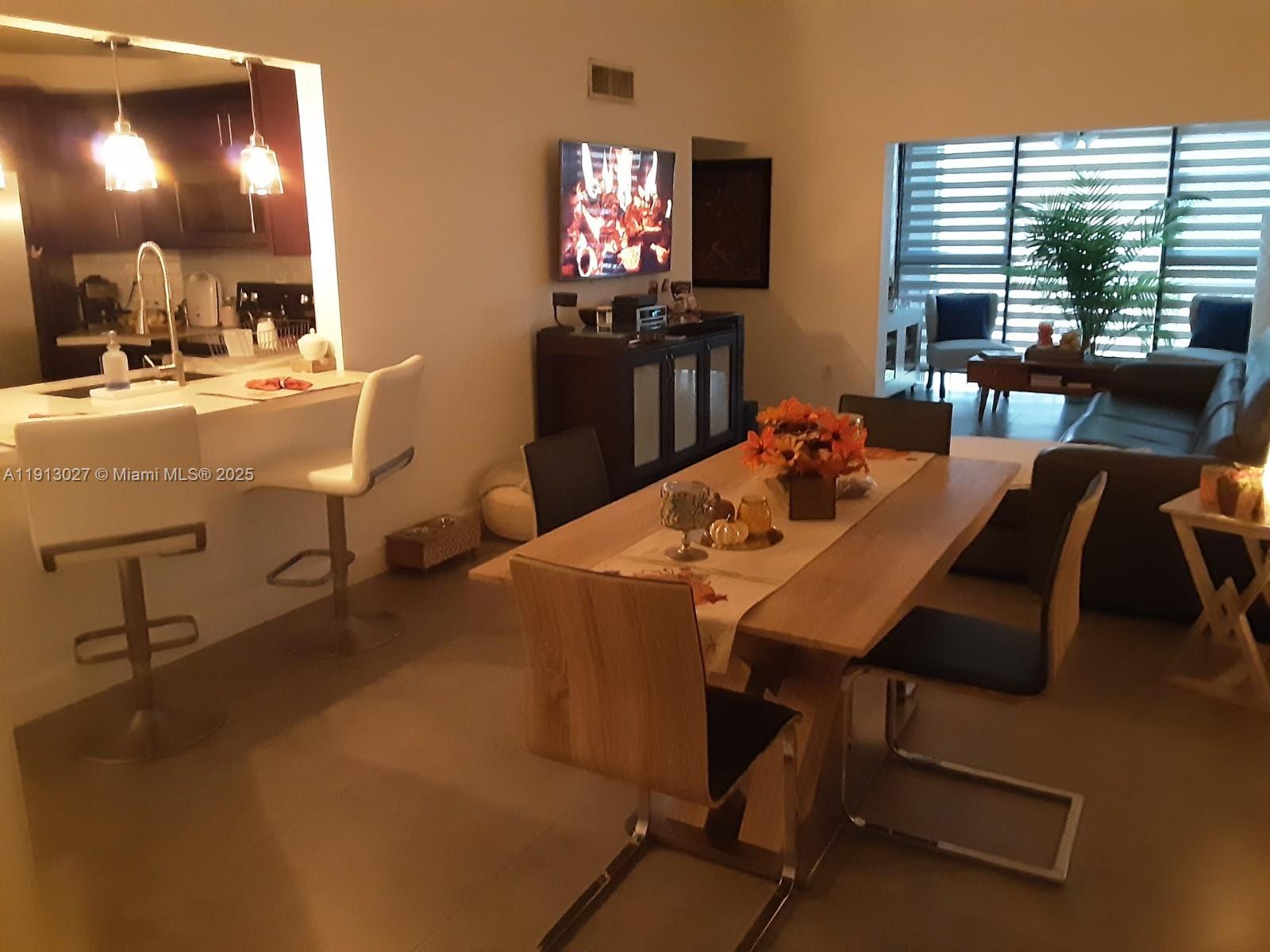 9409 Fontainebleau Boulevard, Unit 207 Miami, FL 33172 - Photo 4 of 19 a view of a dining room with furniture and window