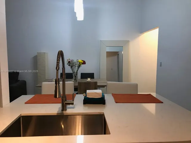 a kitchen with a table chairs and a refrigerator