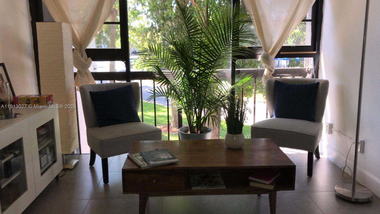 9409 Fontainebleau Boulevard, Unit 207 Miami, FL 33172 - Photo 10 of 19 a view of a dining room with furniture window and wooden floor
