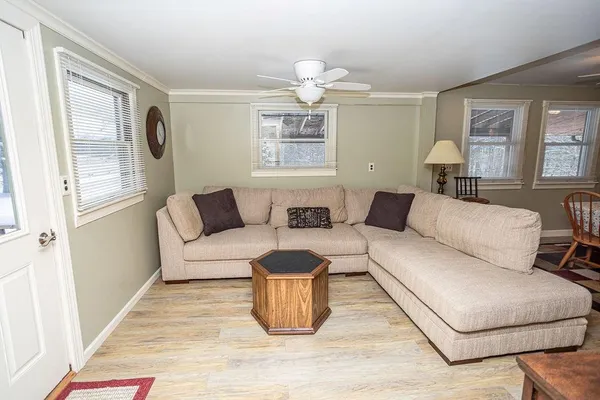 a very nice looking kitchen with granite countertop a stove a sink a dining table and chairs