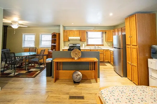 a kitchen with stainless steel appliances granite countertop a refrigerator a stove and a sink