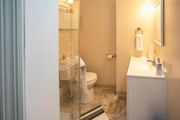 a white toilet sitting next to a bathroom sink