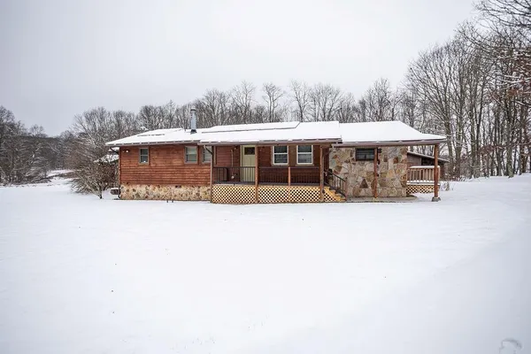 a view of a house with a yard and sitting area