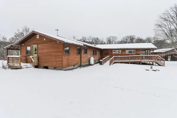 a view of a house with a wooden bench