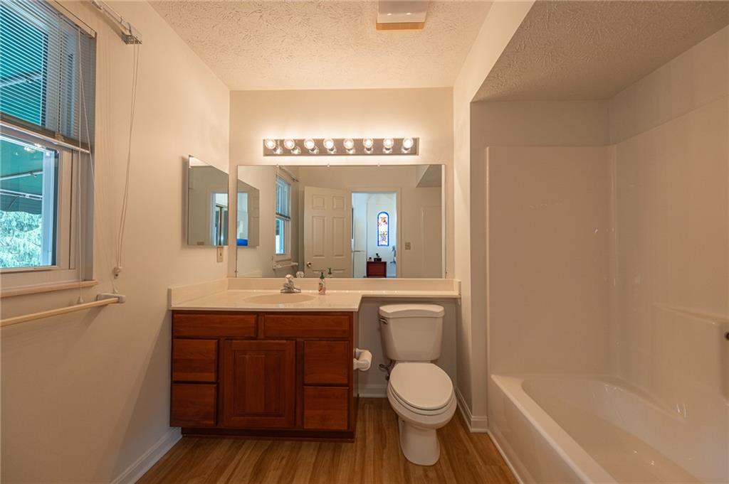 306 Georgetown Lane Export, PA 15632 - Photo 14 of 35 a bathroom with a toilet a sink a tub and mirror