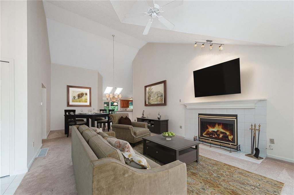 306 Georgetown Lane Export, PA 15632 - Photo 7 of 35 a living room with furniture a fireplace and a flat screen tv